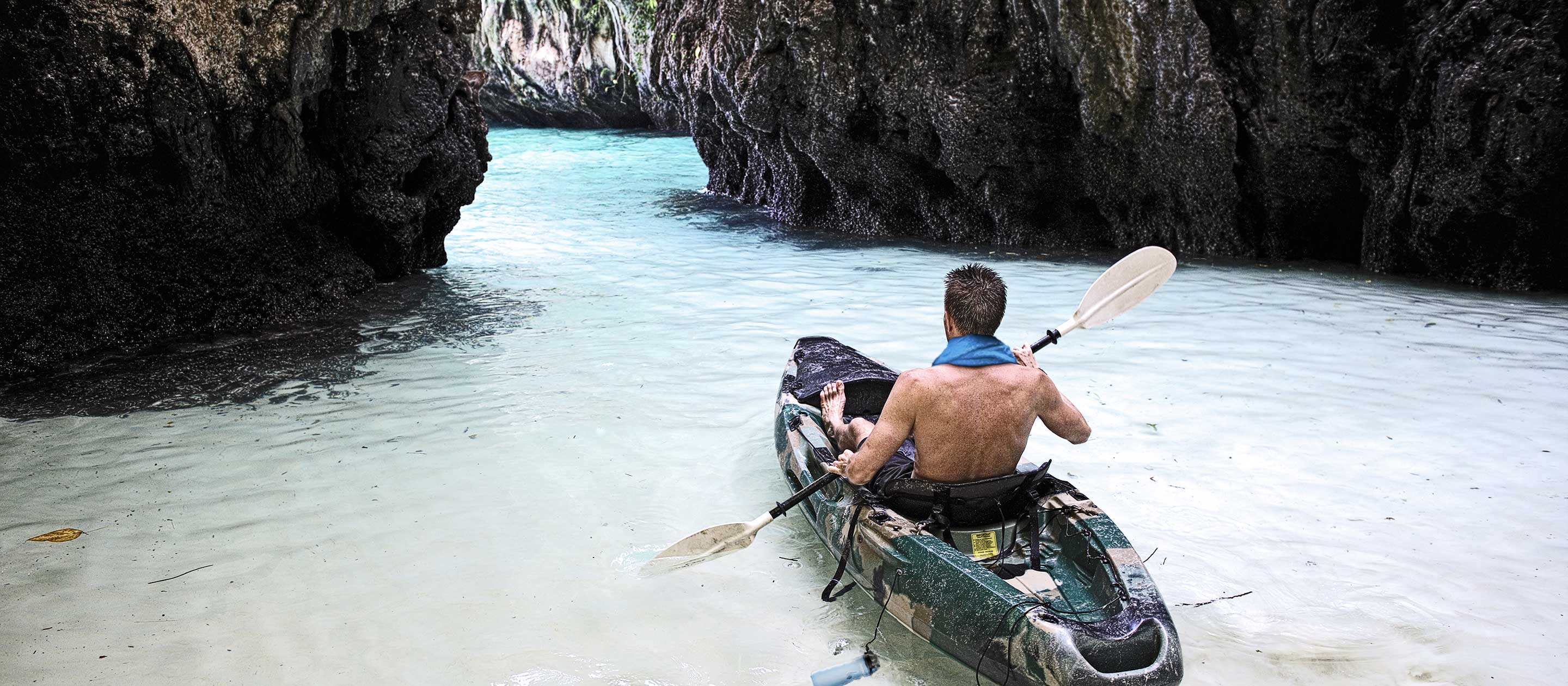 Photo: Guy in kayak in a cove